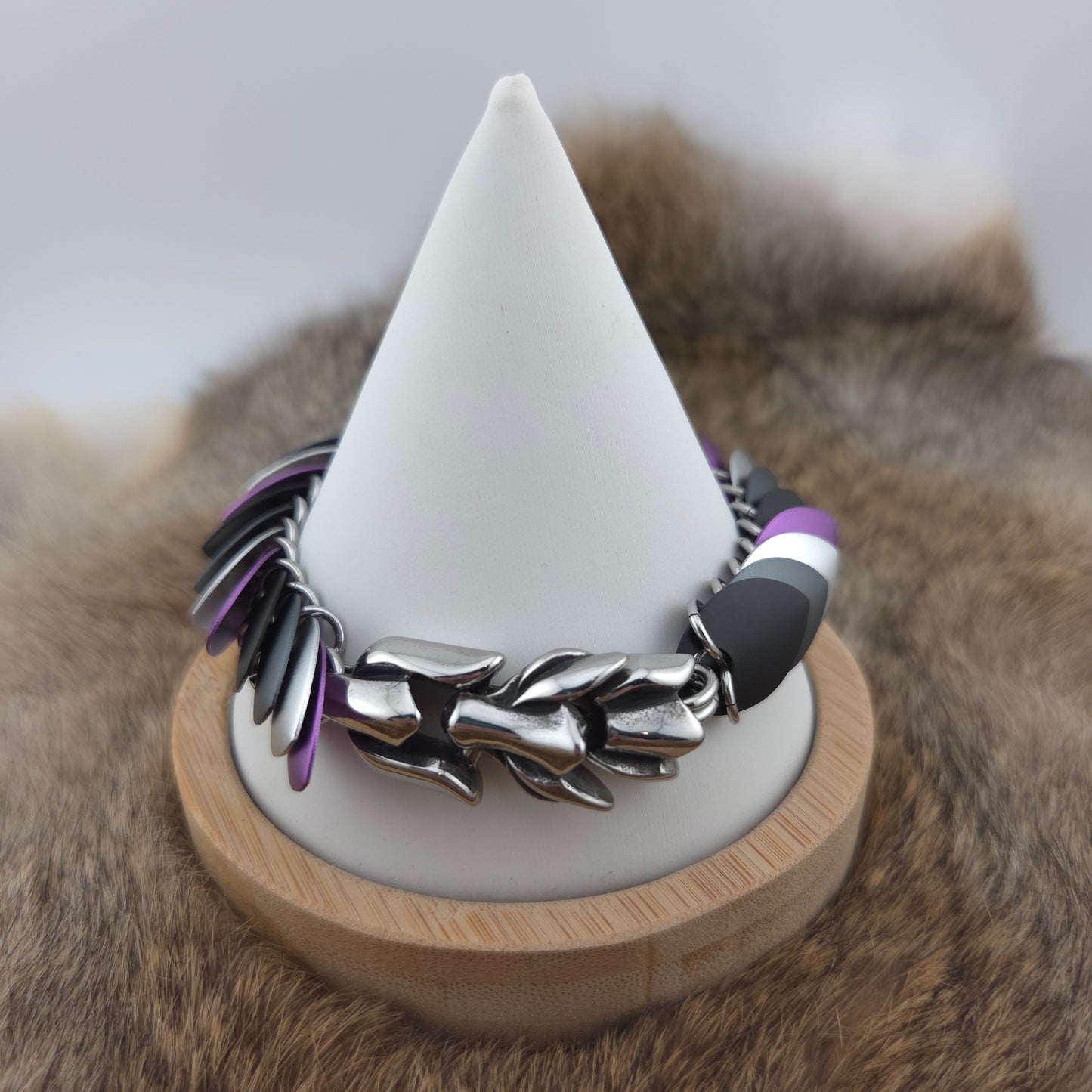 Dragon Scale Bracelet, with a stainless steel spine, premium anodized aluminum scales, and a solid stainless steel spring clasp shaped as a Dragon head.