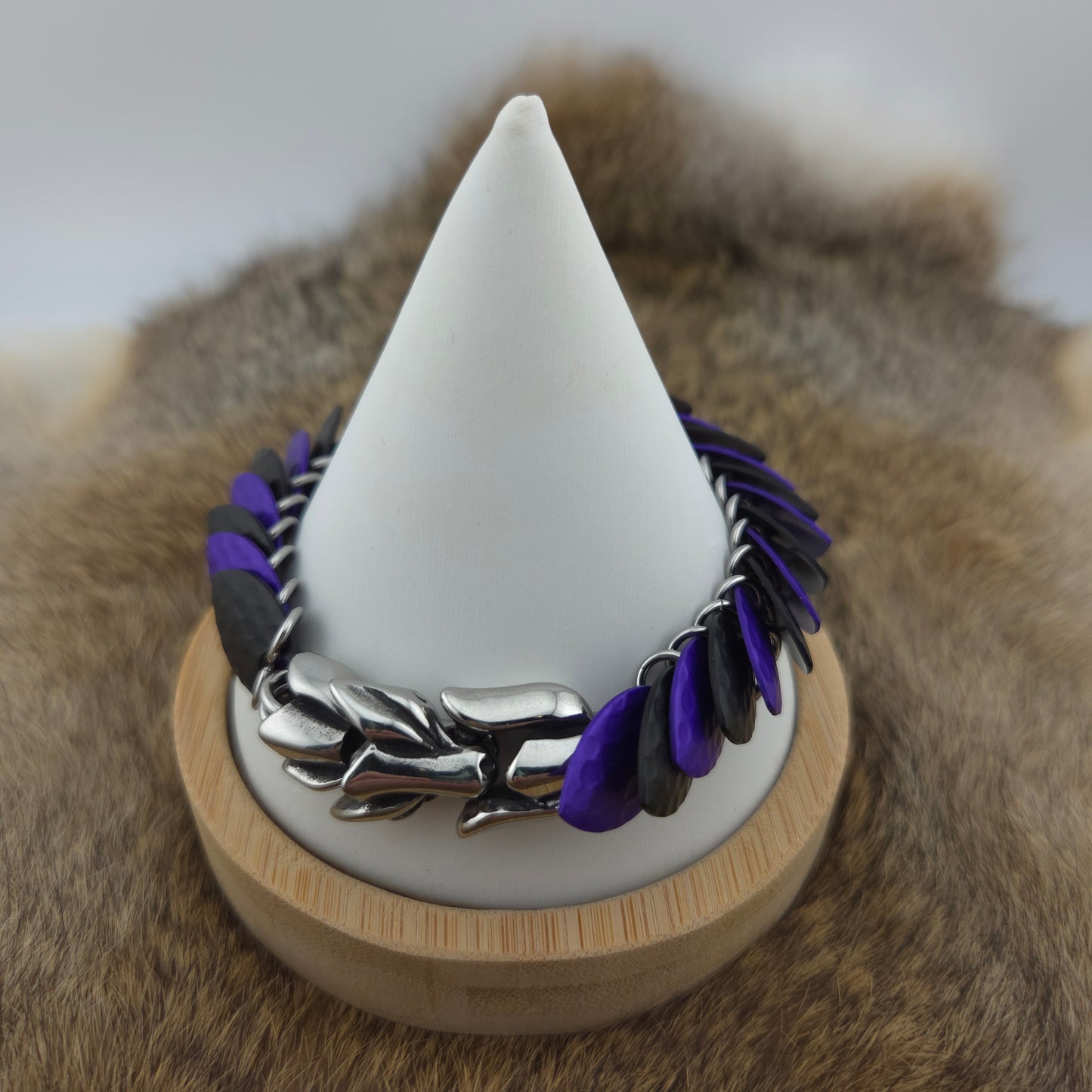 Dragon Scale Bracelet, with a stainless steel spine, premium anodized aluminum scales, and a solid stainless steel spring clasp shaped as a Dragon head.