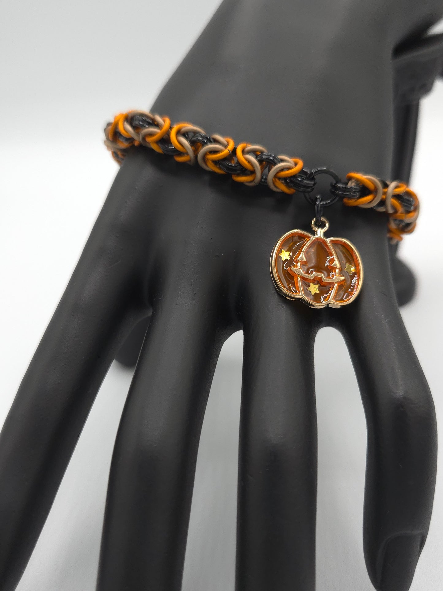 Black, Matte Taupe, and Matte Orange Bracelet with a Stary Pumpkin