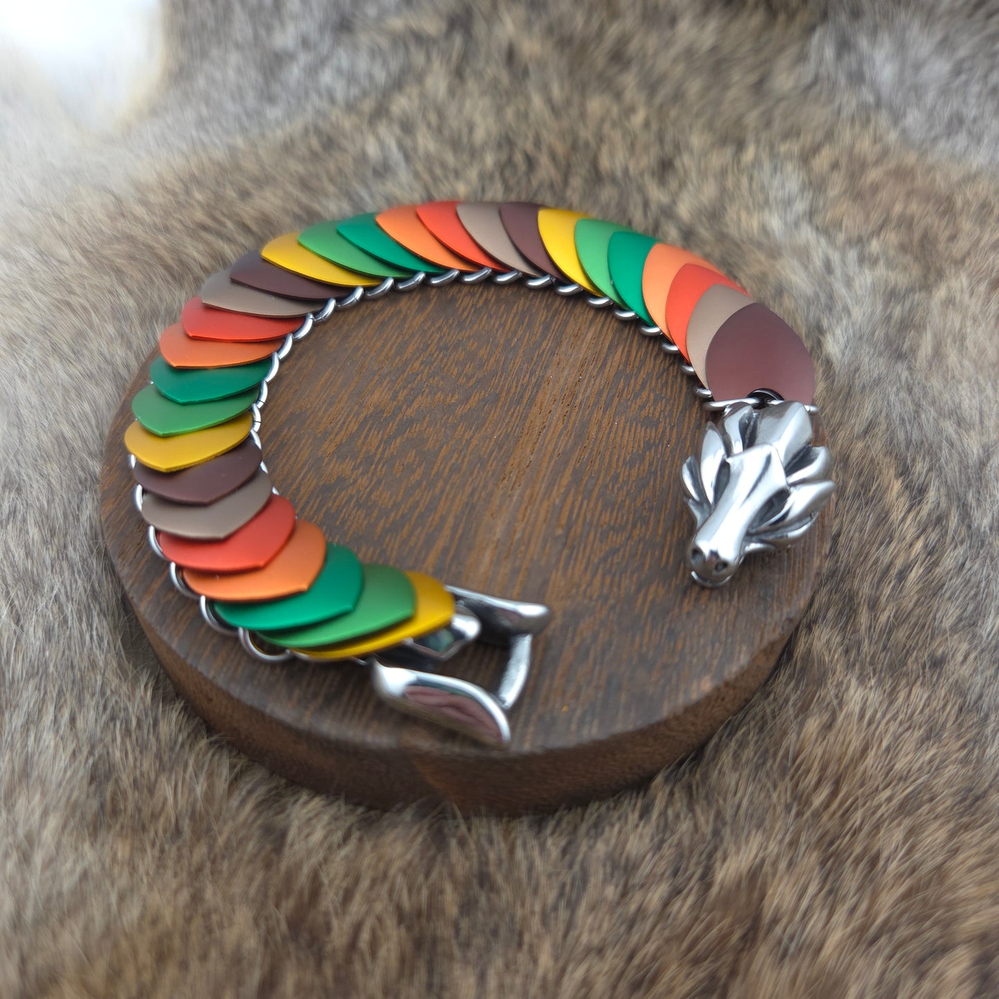 Dragon Scale Bracelet, with a stainless steel spine, premium anodized aluminum scales, and a solid stainless steel spring clasp shaped as a Dragon head.