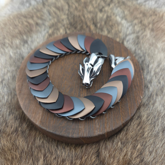 A dragon scale bracelet, handwoven with aluminum scales on a stainless steel spine with a solid stainless steel spring clasp.