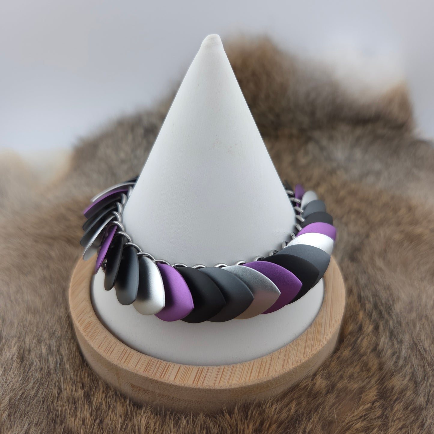 Dragon Scale Bracelet, with a stainless steel spine, premium anodized aluminum scales, and a solid stainless steel spring clasp shaped as a Dragon head.