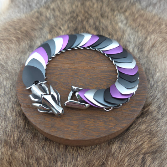 Dragon Scale Bracelet, with a stainless steel spine, premium anodized aluminum scales, and a solid stainless steel spring clasp shaped as a Dragon head.