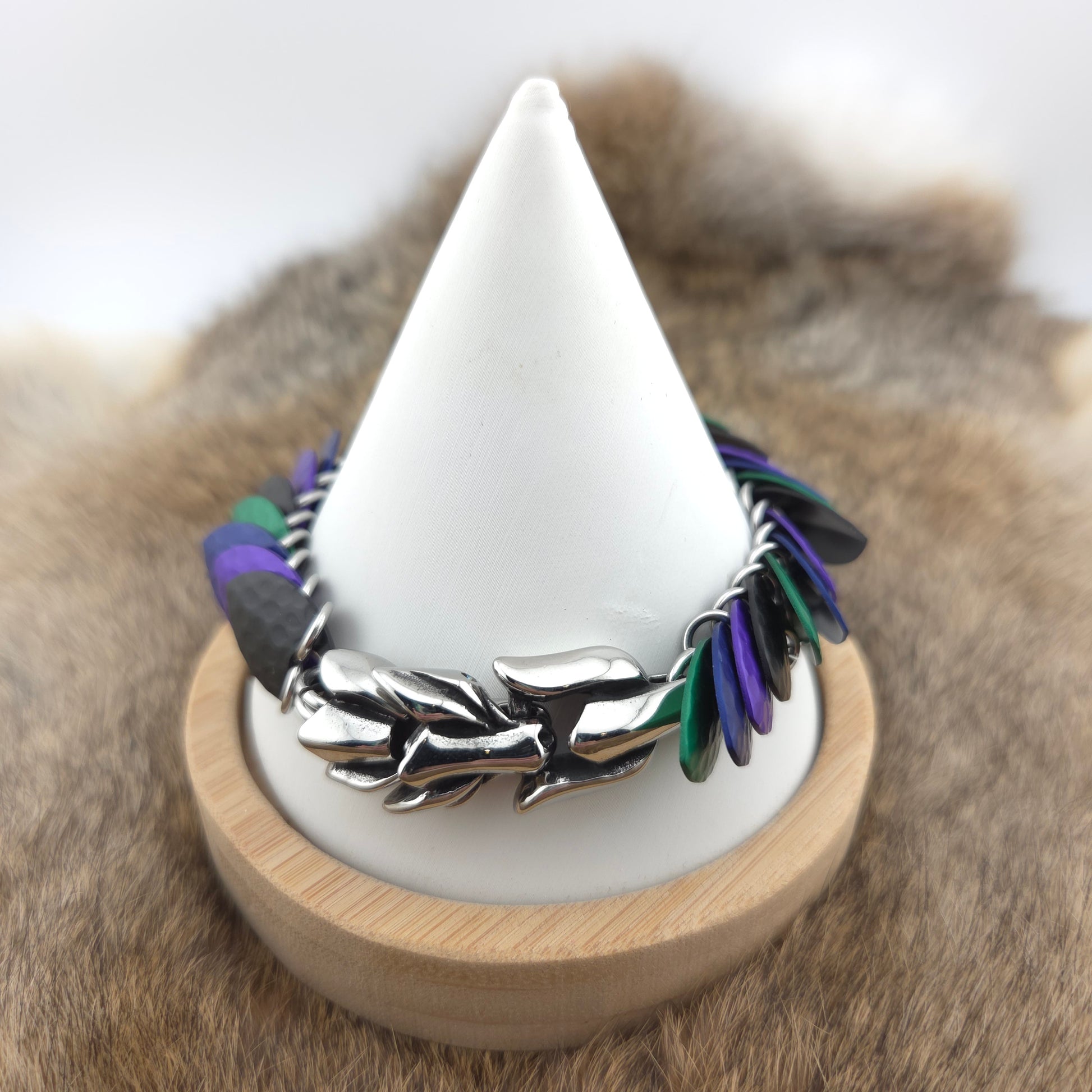 A dragon scale bracelet, handwoven with aluminum scales on a stainless steel spine with a solid stainless steel spring clasp.