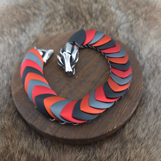 A dragon scale bracelet, handwoven with aluminum scales on a stainless steel spine with a solid stainless steel spring clasp.