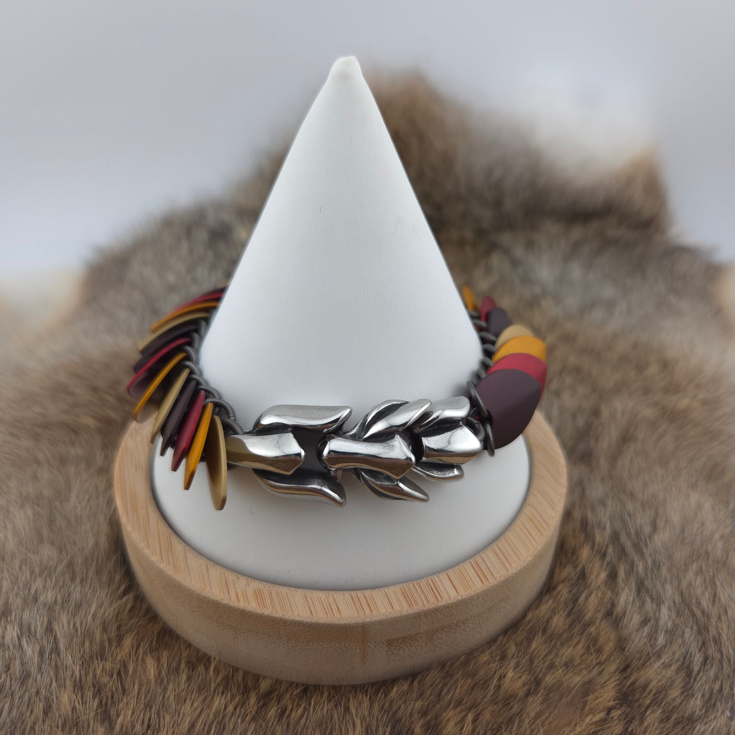 Dragon Scale Bracelet, with a stainless steel spine, premium anodized aluminum scales, and a solid stainless steel spring clasp shaped as a Dragon head.