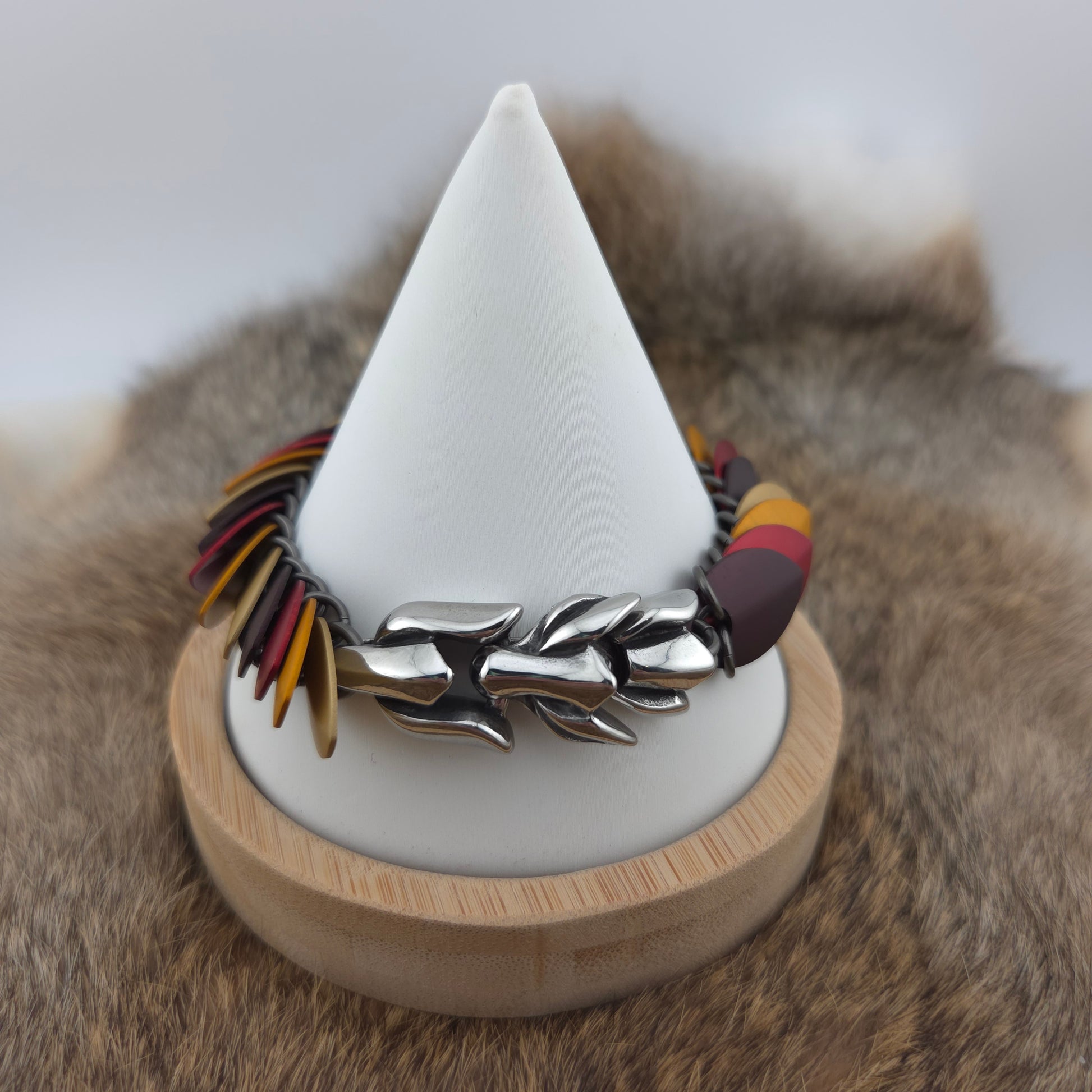 Dragon Scale Bracelet, with a stainless steel spine, premium anodized aluminum scales, and a solid stainless steel spring clasp shaped as a Dragon head.
