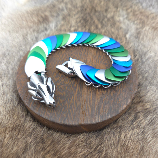 Dragon Scale Bracelet, with a stainless steel spine, premium anodized aluminum scales, and a solid stainless steel spring clasp shaped as a Dragon head.