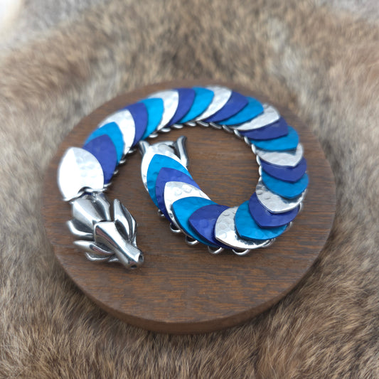 Dragon Scale Bracelet, with a stainless steel spine, premium anodized aluminum scales, and a solid stainless steel spring clasp shaped as a Dragon head.