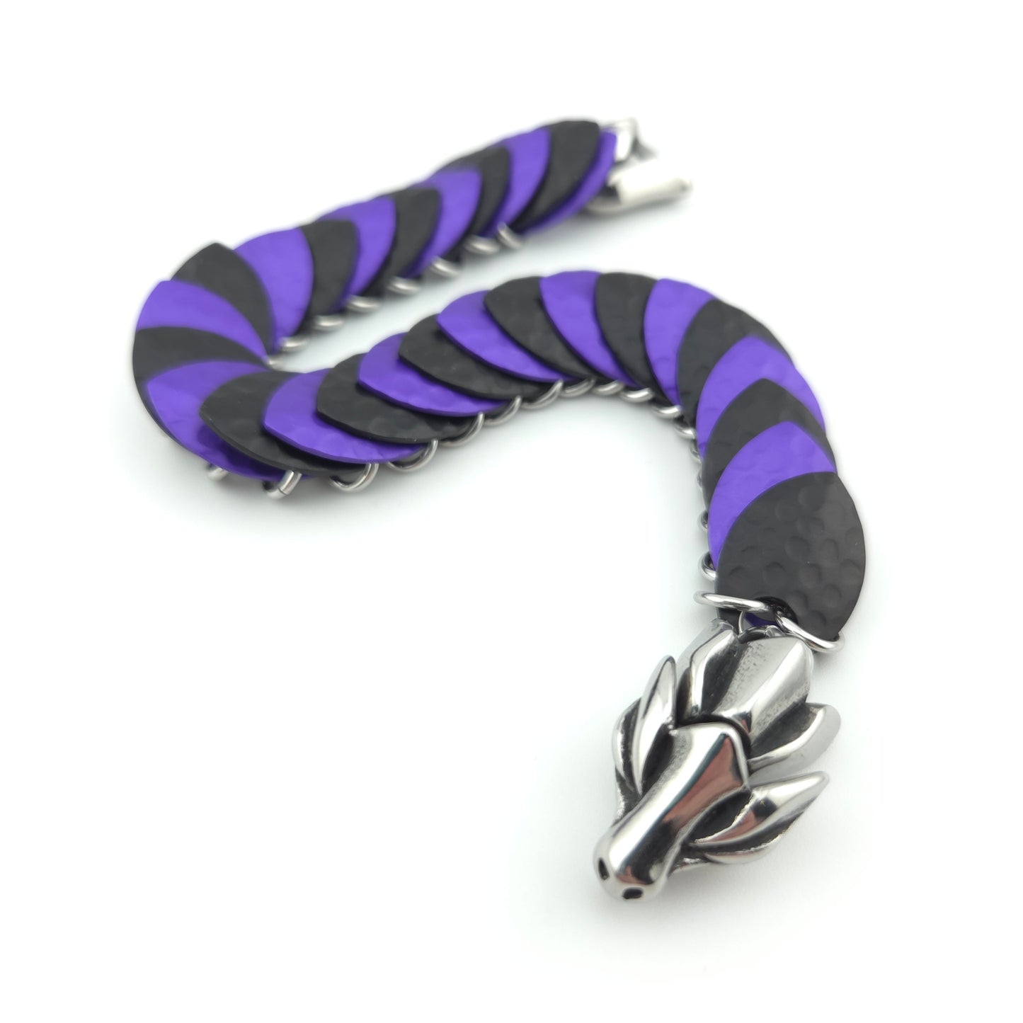 Dragon Scale Bracelet, with a stainless steel spine, premium anodized aluminum scales, and a solid stainless steel spring clasp shaped as a Dragon head.