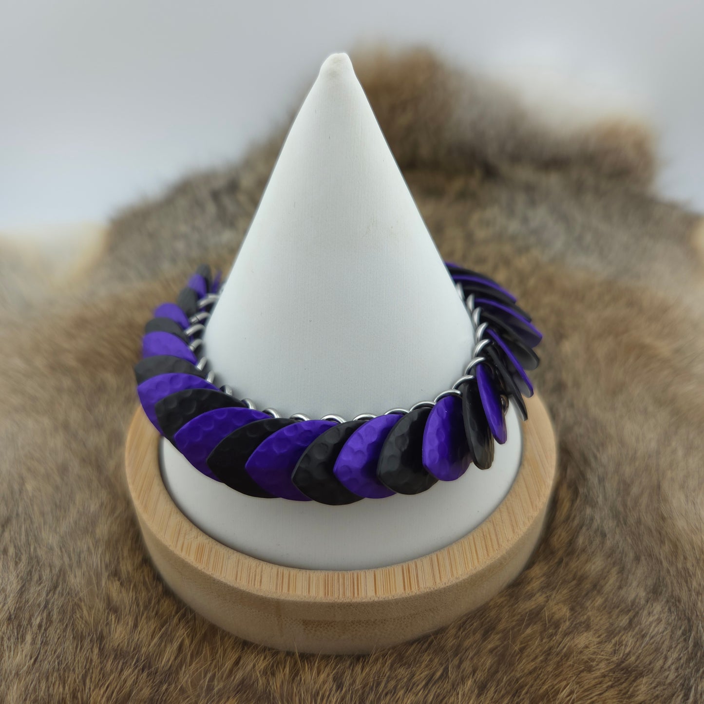 Dragon Scale Bracelet, with a stainless steel spine, premium anodized aluminum scales, and a solid stainless steel spring clasp shaped as a Dragon head.