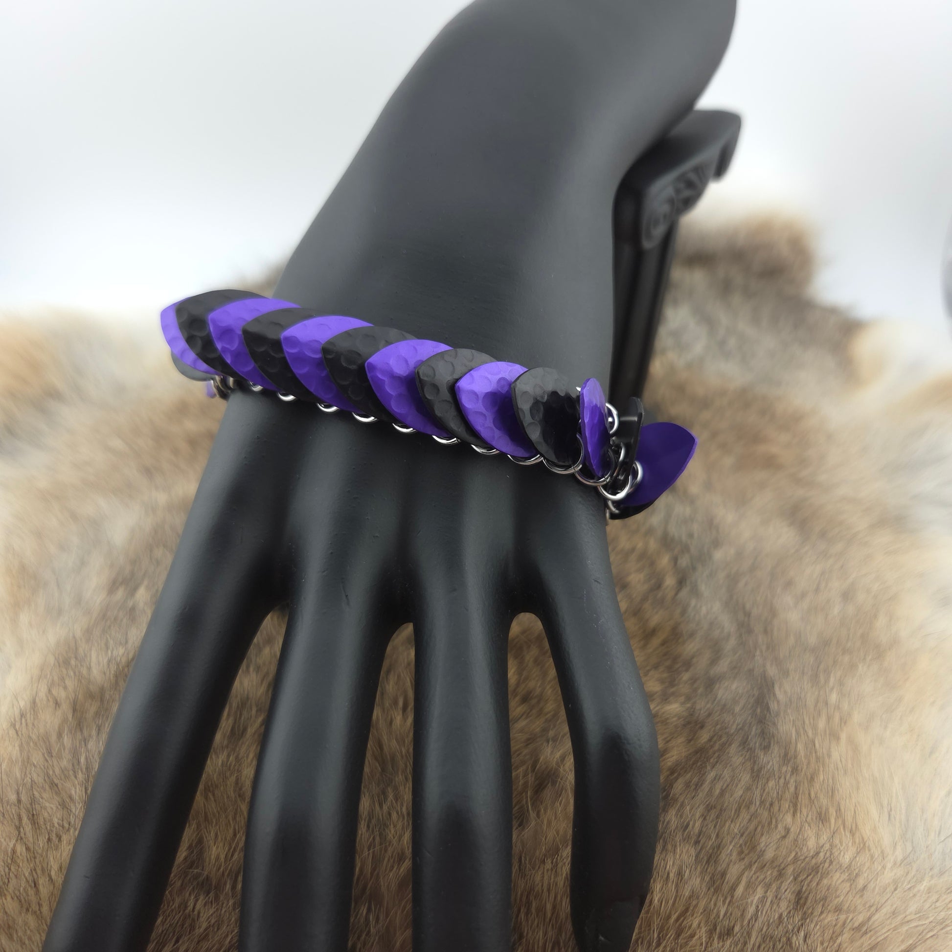 Dragon Scale Bracelet, with a stainless steel spine, premium anodized aluminum scales, and a solid stainless steel spring clasp shaped as a Dragon head.
