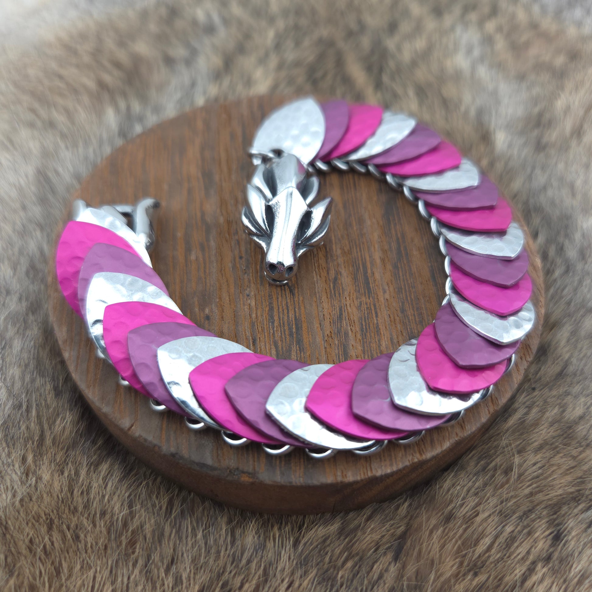 Dragon Scale Bracelet, with a stainless steel spine, premium anodized aluminum scales, and a solid stainless steel spring clasp shaped as a Dragon head.