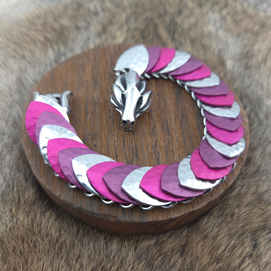 Dragon Scale Bracelet, with a stainless steel spine, premium anodized aluminum scales, and a solid stainless steel spring clasp shaped as a Dragon head.