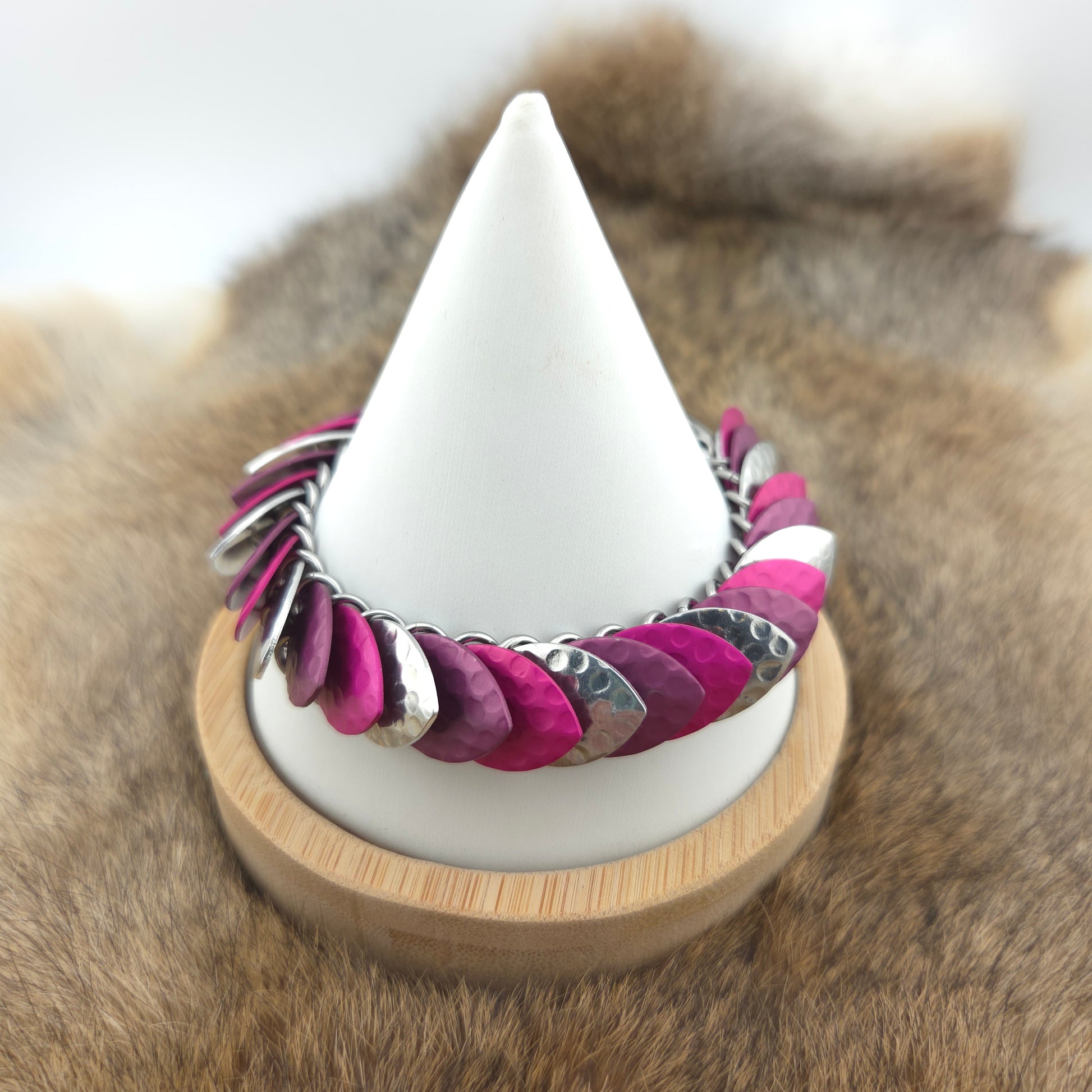 Dragon Scale Bracelet, with a stainless steel spine, premium anodized aluminum scales, and a solid stainless steel spring clasp shaped as a Dragon head.