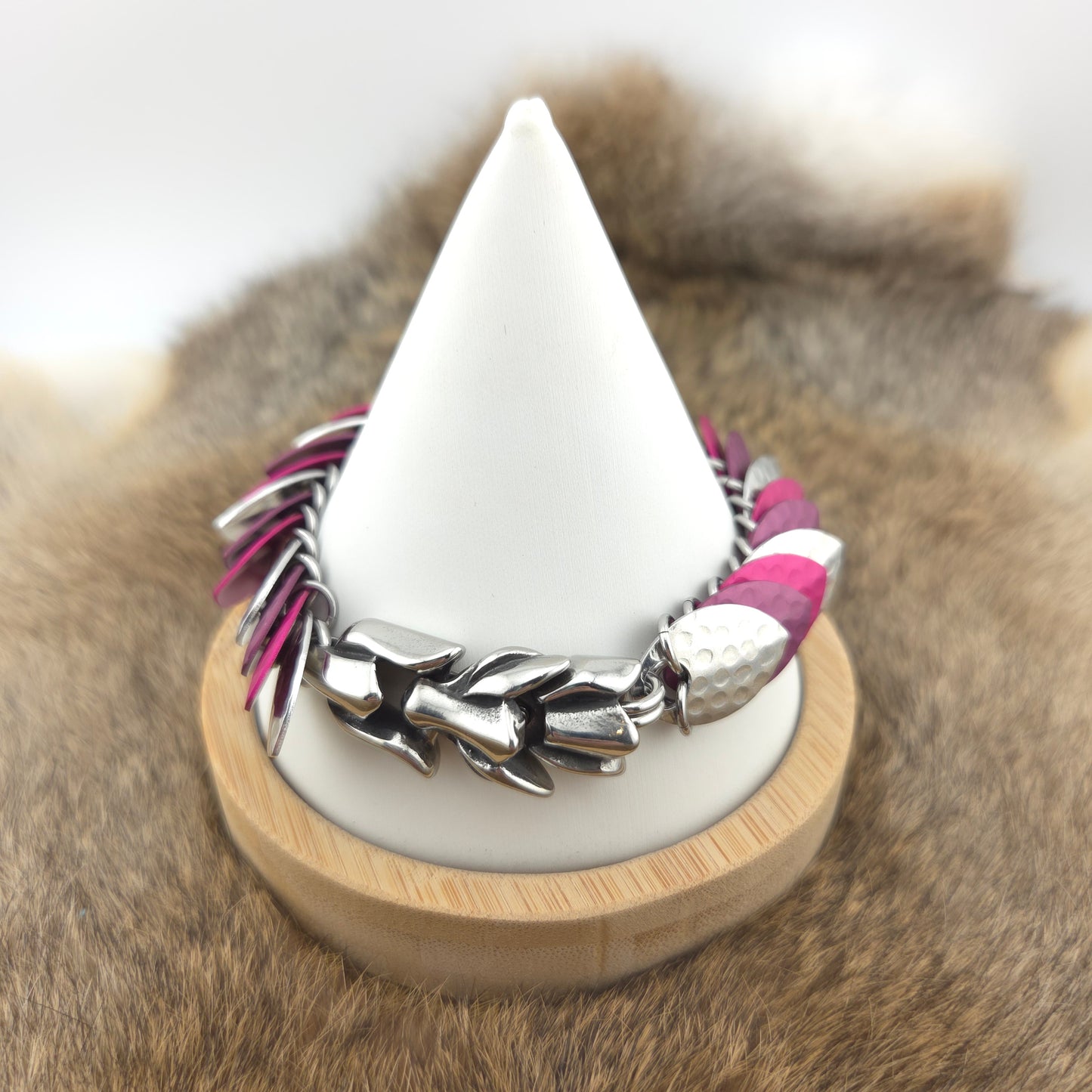Dragon Scale Bracelet, with a stainless steel spine, premium anodized aluminum scales, and a solid stainless steel spring clasp shaped as a Dragon head.
