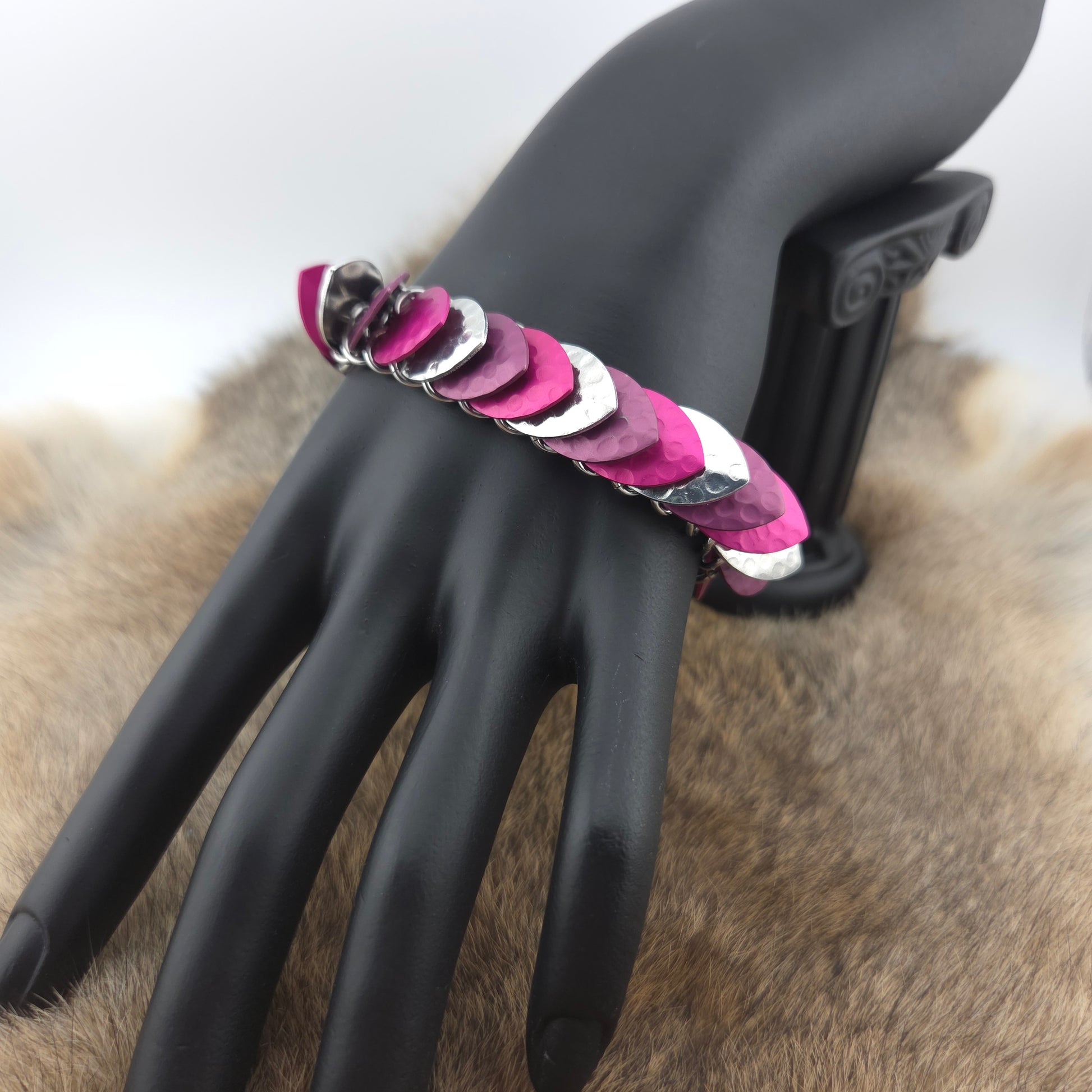 Dragon Scale Bracelet, with a stainless steel spine, premium anodized aluminum scales, and a solid stainless steel spring clasp shaped as a Dragon head.