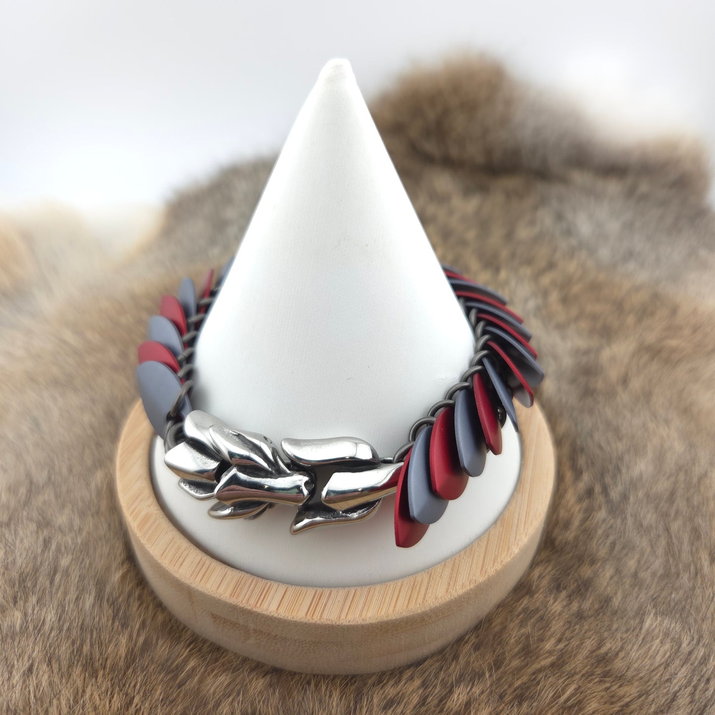 Dragon Scale Bracelet, with a stainless steel spine, premium anodized aluminum scales, and a solid stainless steel spring clasp shaped as a Dragon head.
