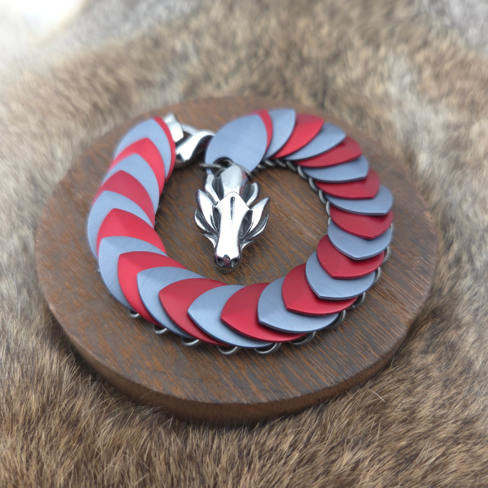 Dragon Scale Bracelet, with a stainless steel spine, premium anodized aluminum scales, and a solid stainless steel spring clasp shaped as a Dragon head.