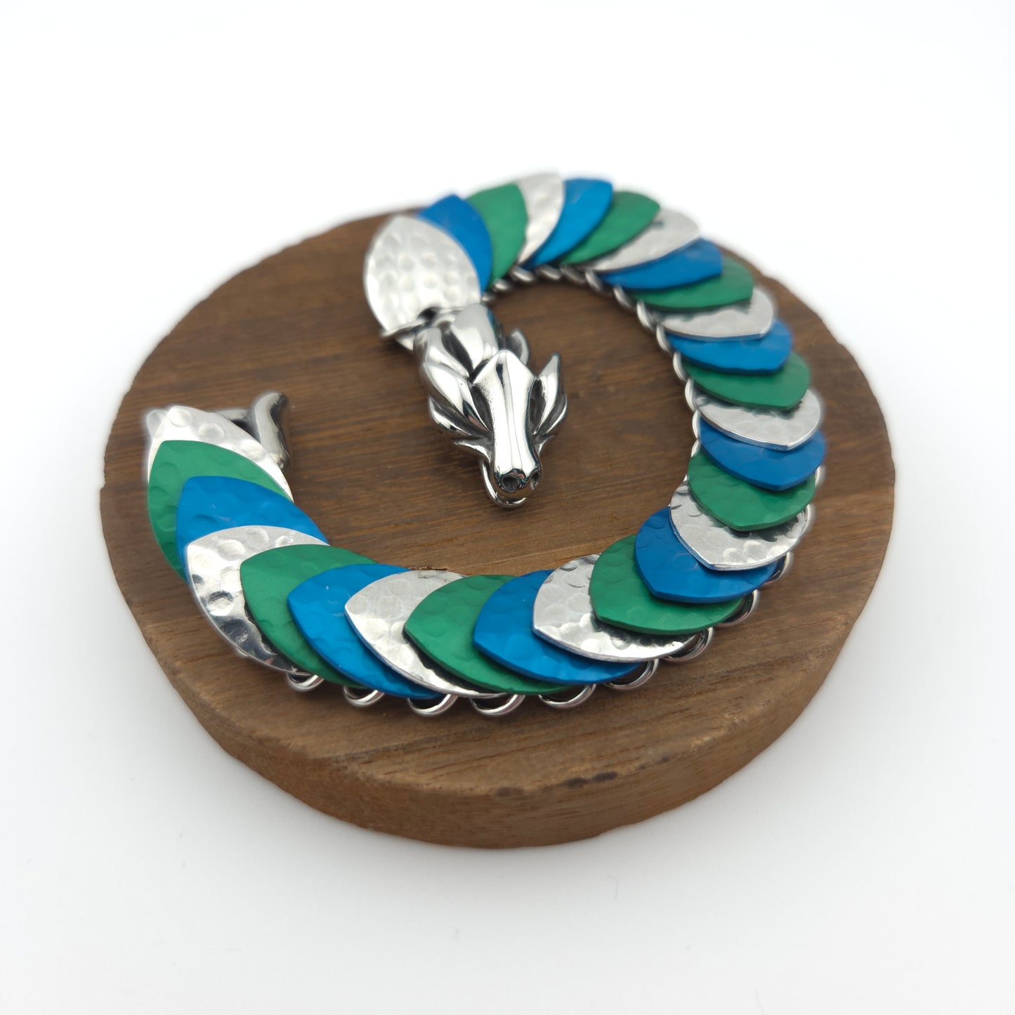 Dragon Scale Bracelet, with a stainless steel spine, premium anodized aluminum scales, and a solid stainless steel spring clasp shaped as a Dragon head.