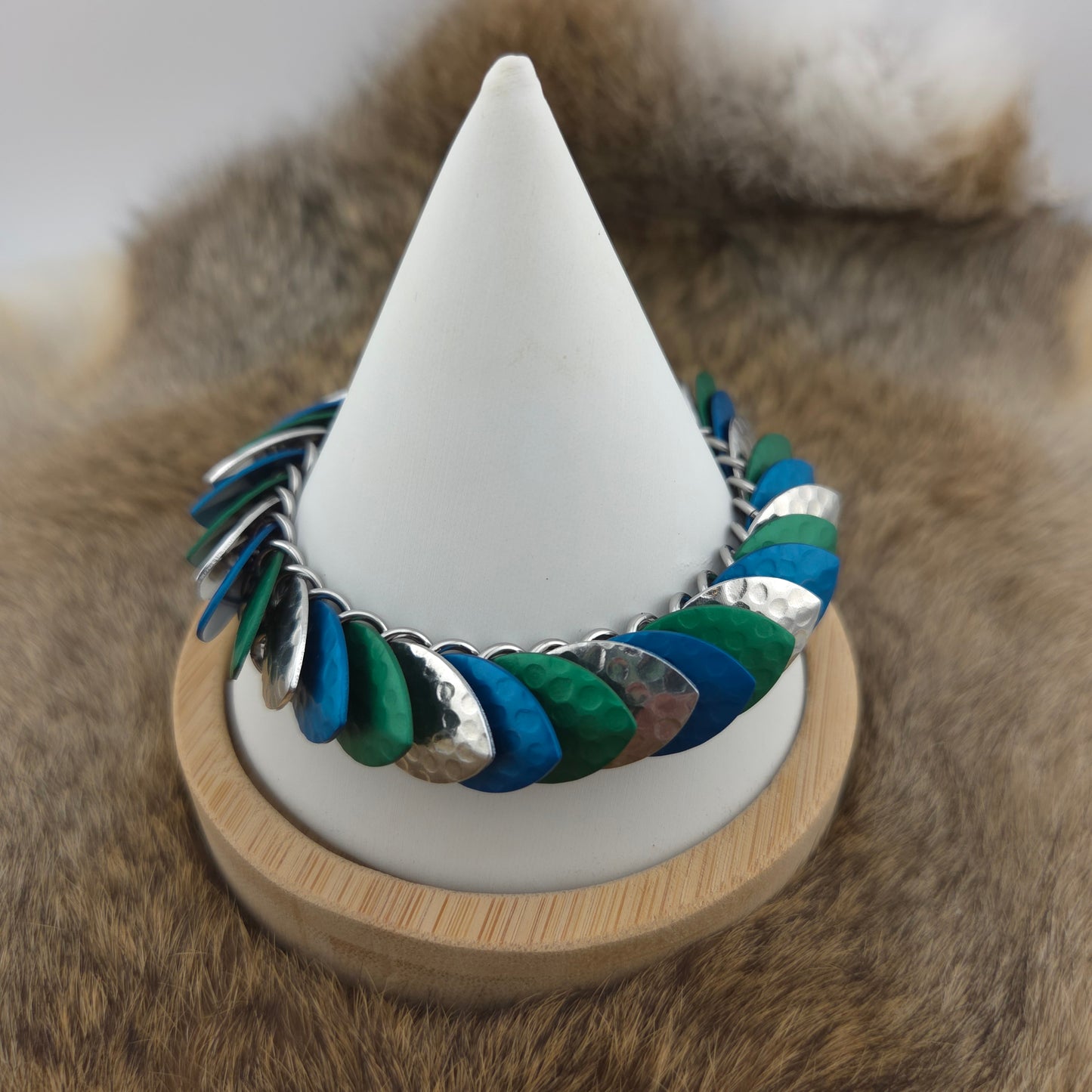 Dragon Scale Bracelet, with a stainless steel spine, premium anodized aluminum scales, and a solid stainless steel spring clasp shaped as a Dragon head.