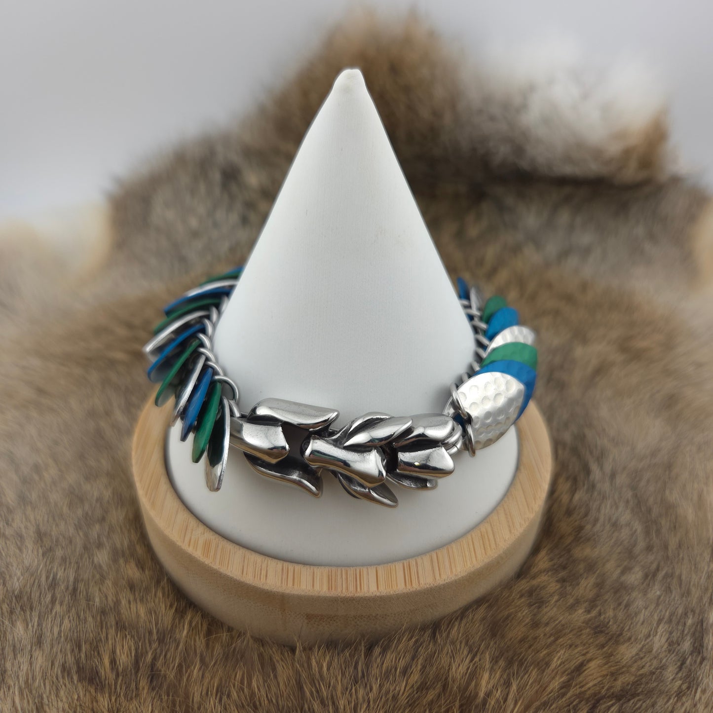 Dragon Scale Bracelet, with a stainless steel spine, premium anodized aluminum scales, and a solid stainless steel spring clasp shaped as a Dragon head.