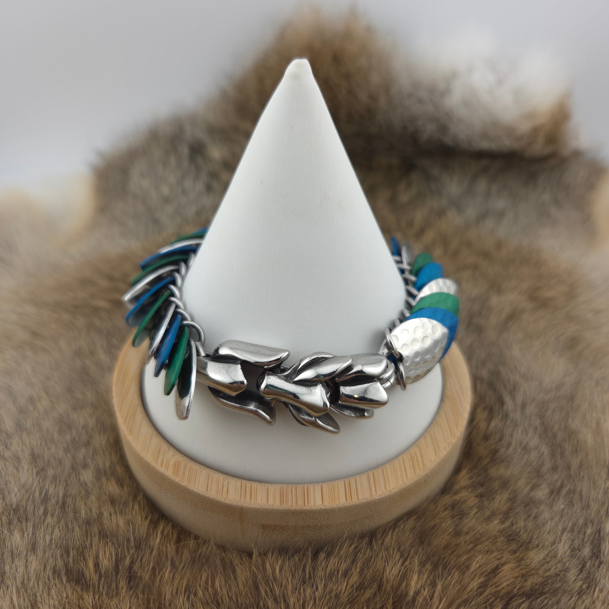 Dragon Scale Bracelet, with a stainless steel spine, premium anodized aluminum scales, and a solid stainless steel spring clasp shaped as a Dragon head.