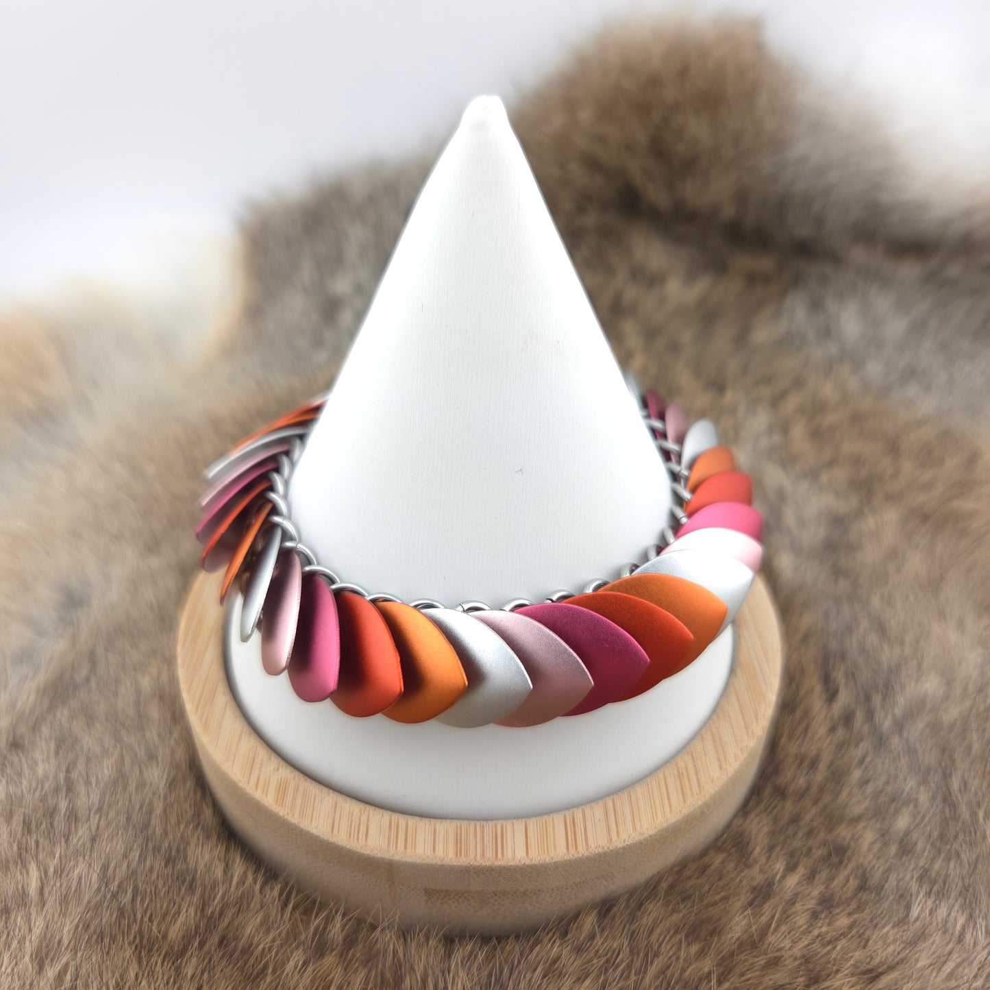 Dragon Scale Bracelet, with a stainless steel spine, premium anodized aluminum scales, and a solid stainless steel spring clasp shaped as a Dragon head.
