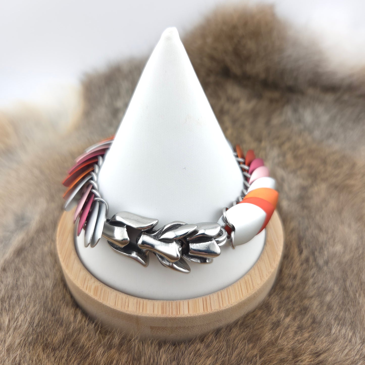 Dragon Scale Bracelet, with a stainless steel spine, premium anodized aluminum scales, and a solid stainless steel spring clasp shaped as a Dragon head.