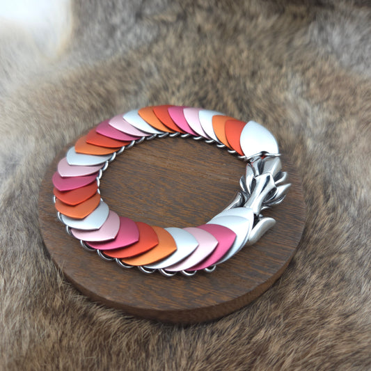 Dragon Scale Bracelet, with a stainless steel spine, premium anodized aluminum scales, and a solid stainless steel spring clasp shaped as a Dragon head.