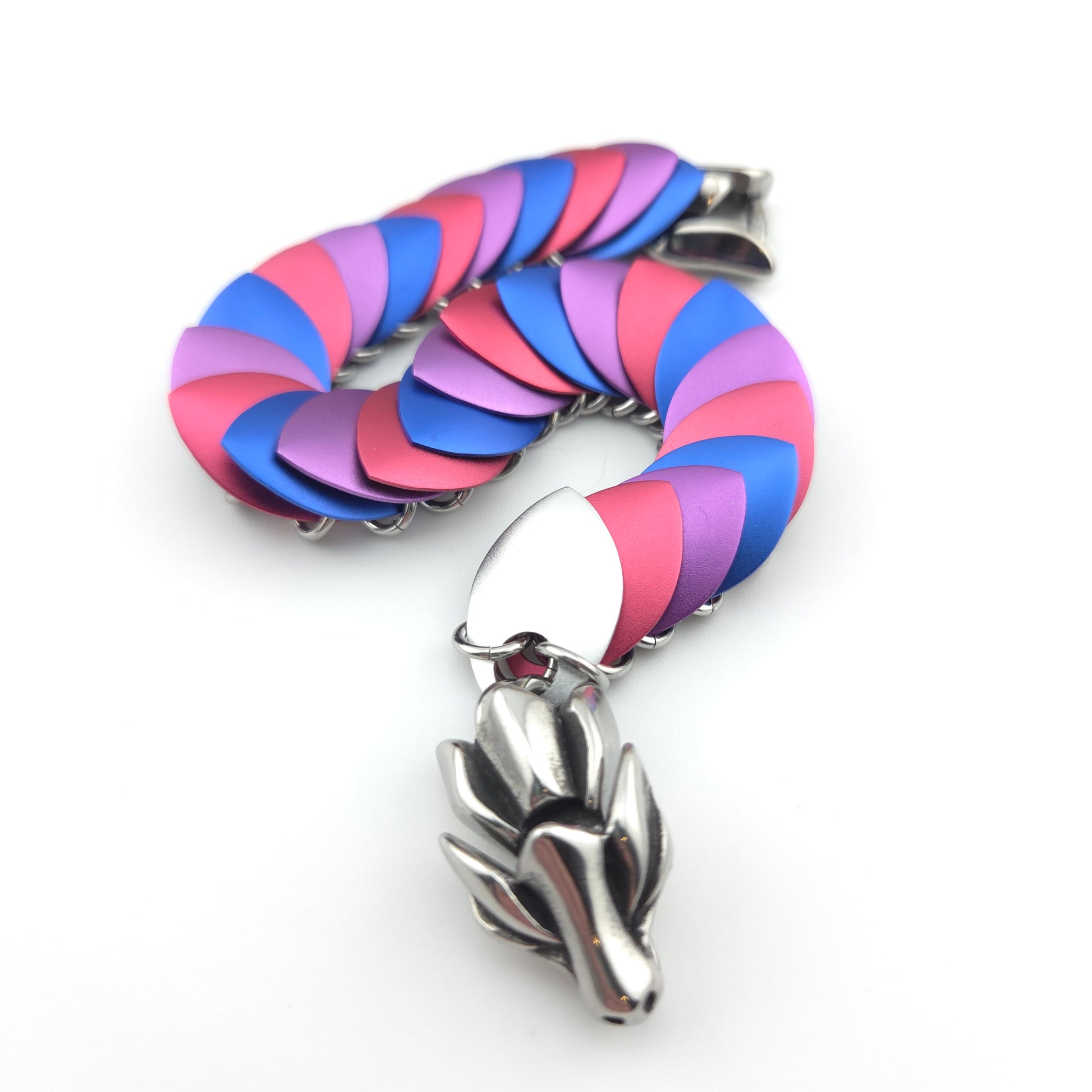 Dragon Scale Bracelet, with a stainless steel spine, premium anodized aluminum scales, and a solid stainless steel spring clasp shaped as a Dragon head.