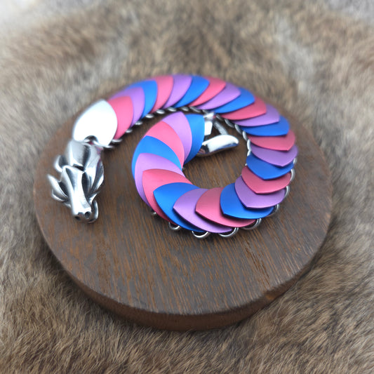 Dragon Scale Bracelet, with a stainless steel spine, premium anodized aluminum scales, and a solid stainless steel spring clasp shaped as a Dragon head.