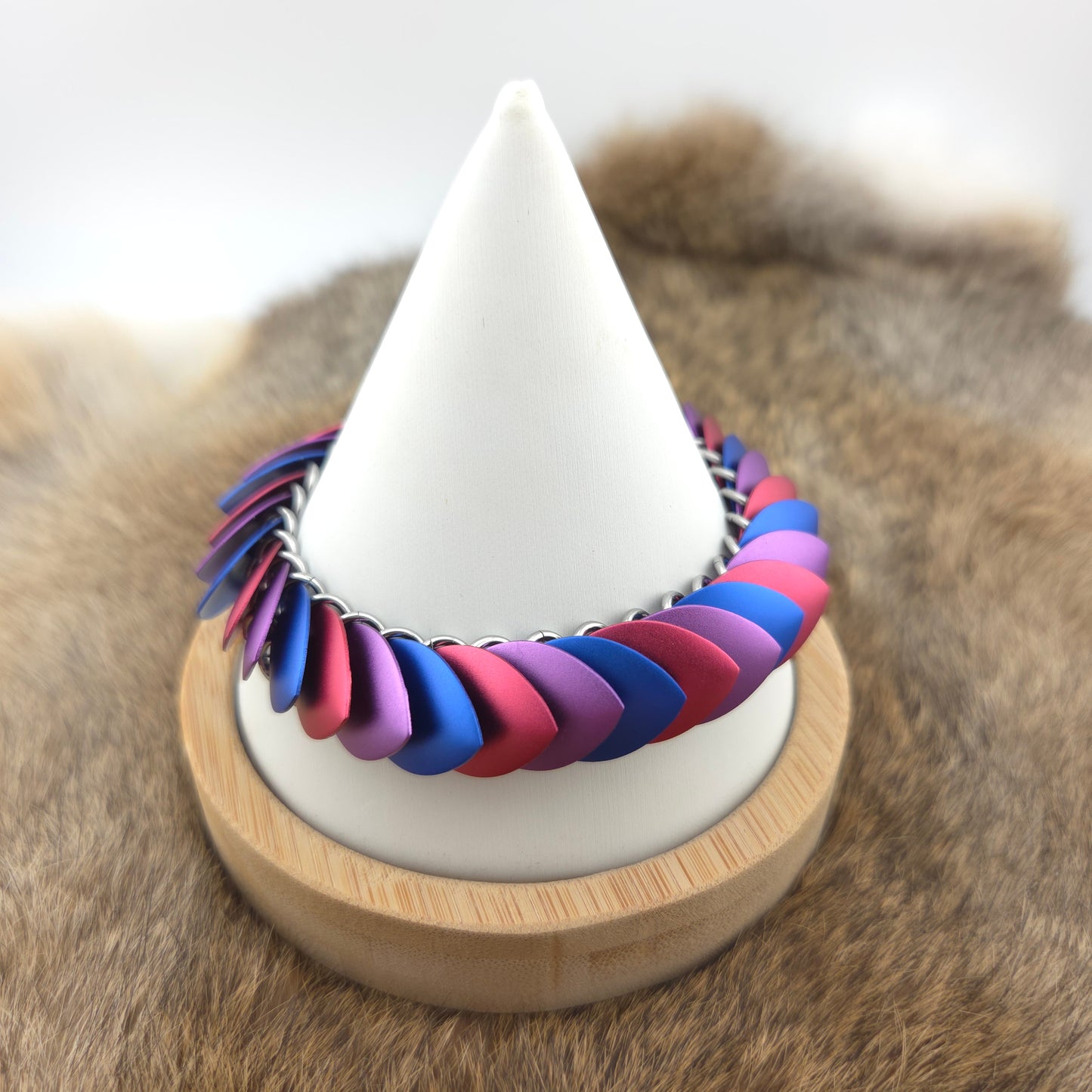 Dragon Scale Bracelet, with a stainless steel spine, premium anodized aluminum scales, and a solid stainless steel spring clasp shaped as a Dragon head.
