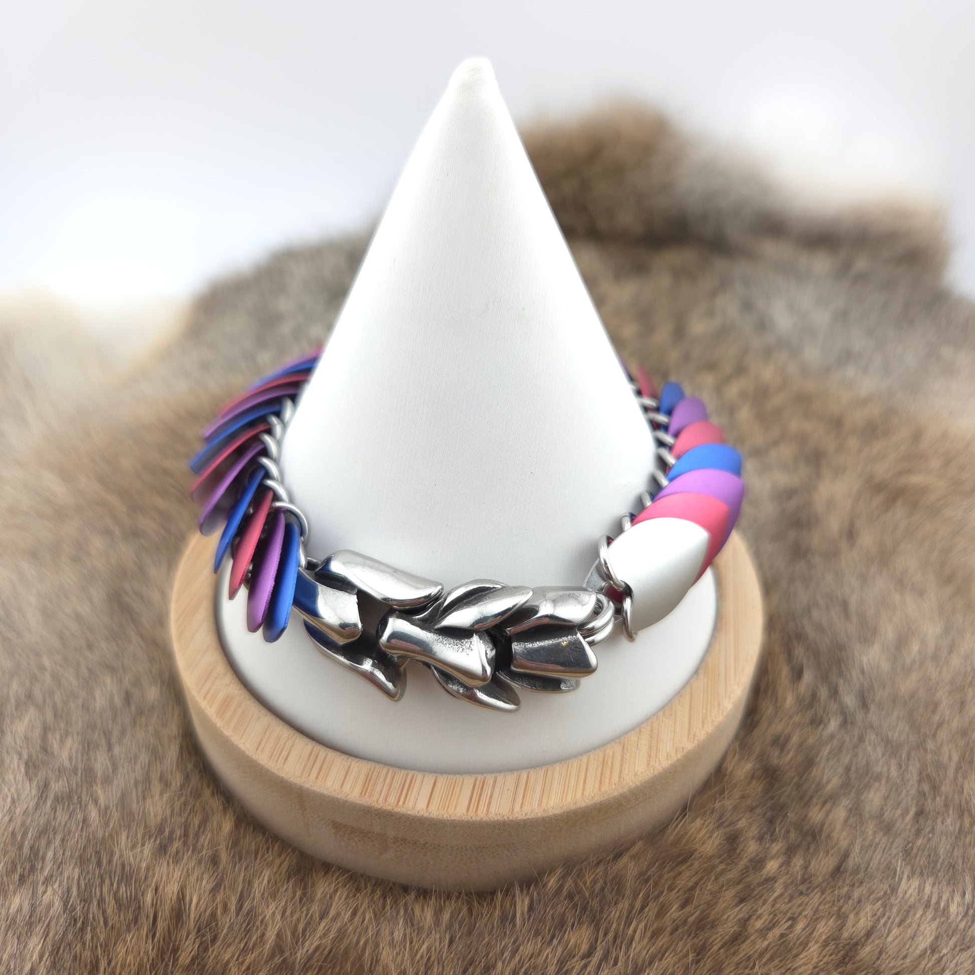Dragon Scale Bracelet, with a stainless steel spine, premium anodized aluminum scales, and a solid stainless steel spring clasp shaped as a Dragon head.