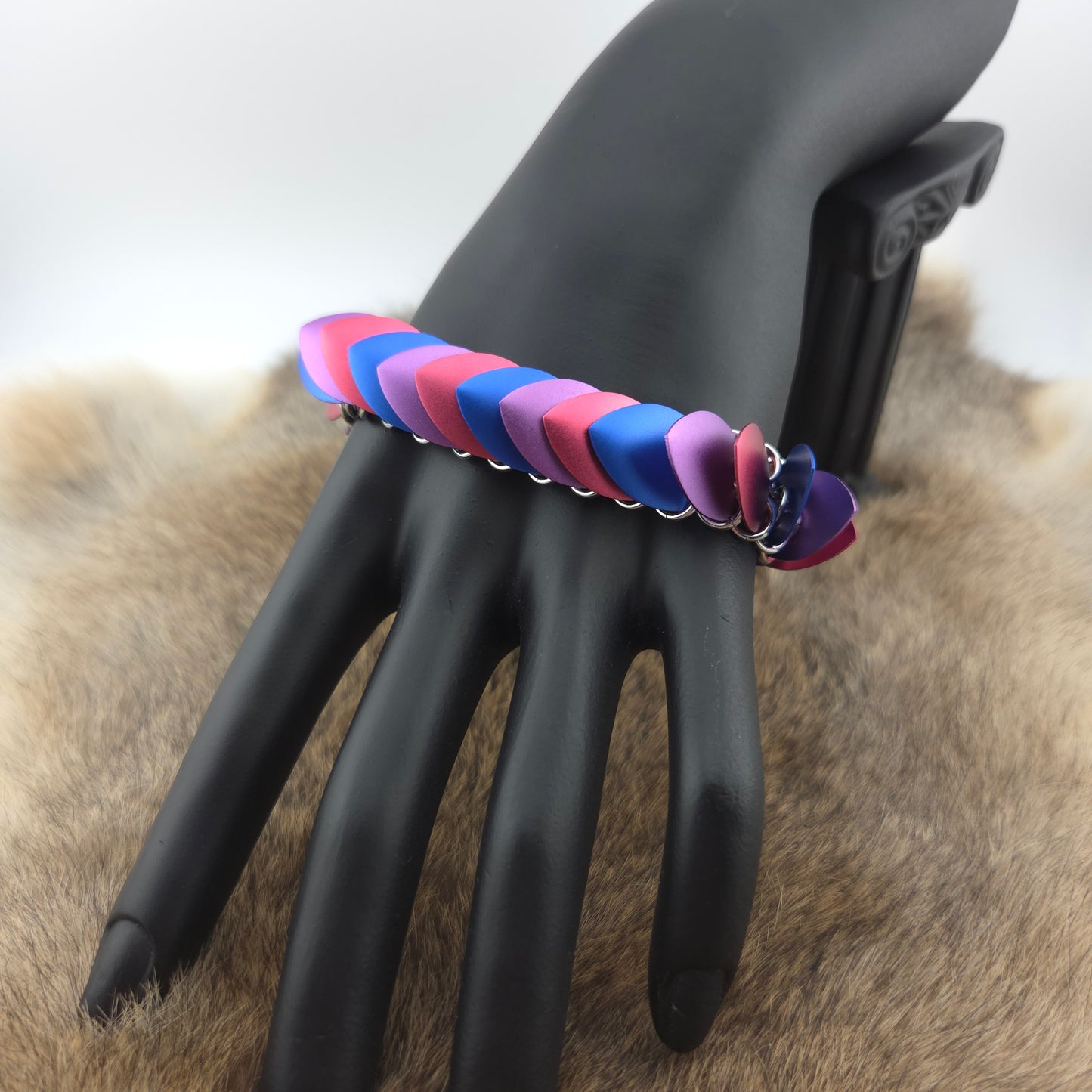 Dragon Scale Bracelet, with a stainless steel spine, premium anodized aluminum scales, and a solid stainless steel spring clasp shaped as a Dragon head.