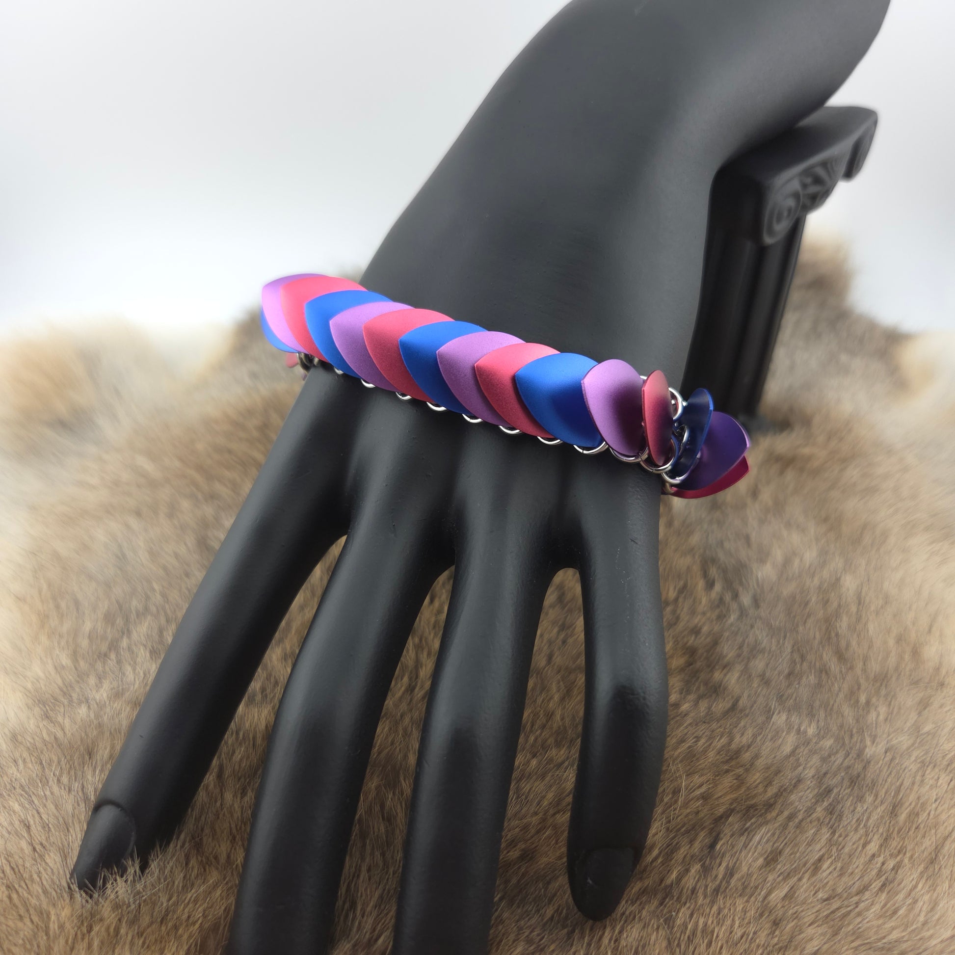 Dragon Scale Bracelet, with a stainless steel spine, premium anodized aluminum scales, and a solid stainless steel spring clasp shaped as a Dragon head.