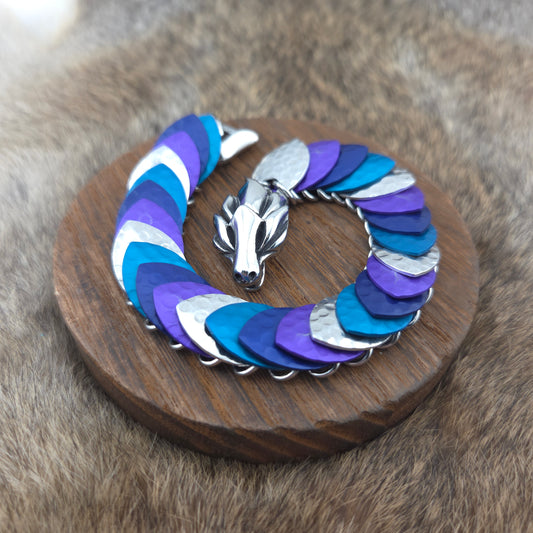 Dragon Scale Bracelet, with a stainless steel spine, premium anodized aluminum scales, and a solid stainless steel spring clasp shaped as a Dragon head.