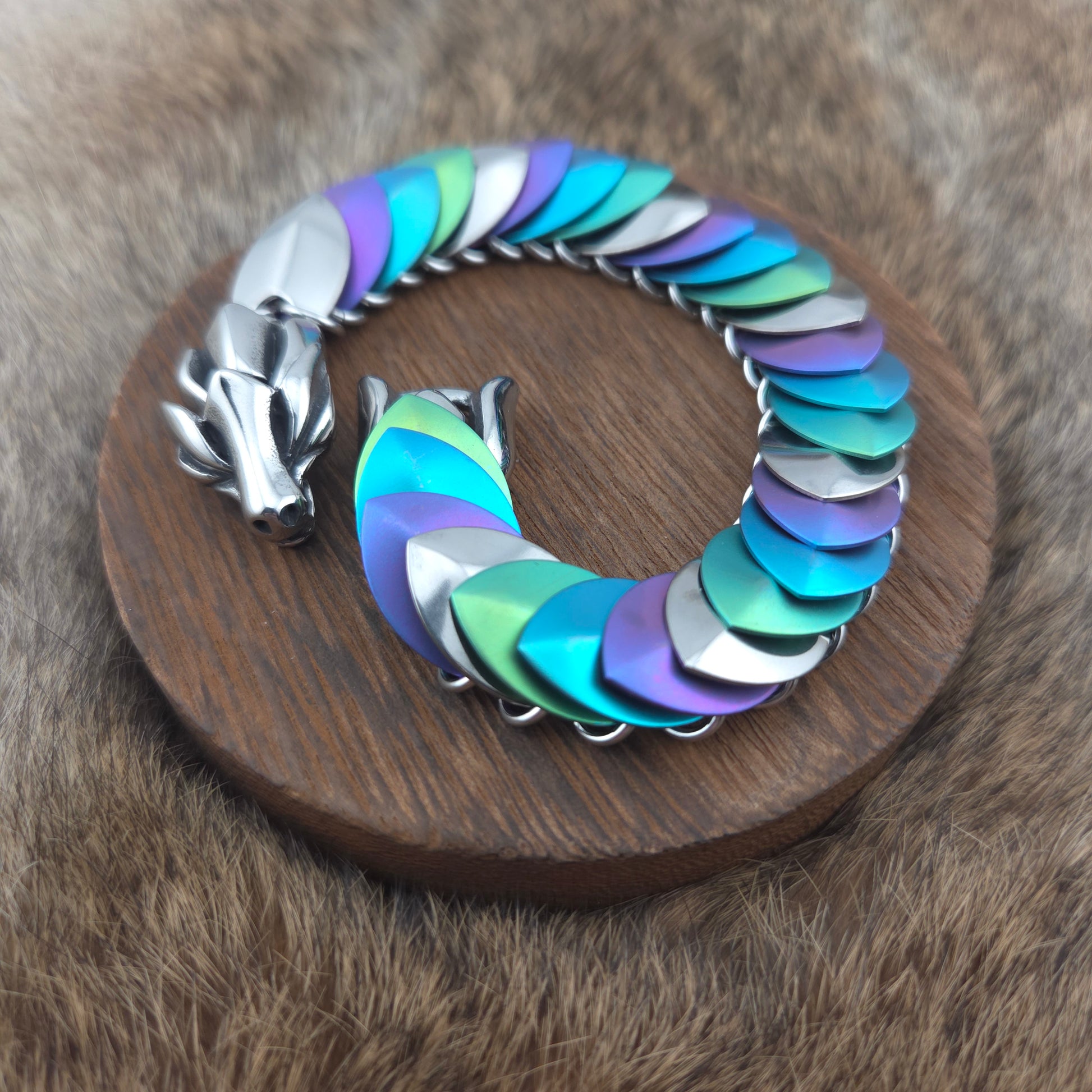 Dragon Scale Bracelet, handwoven with a stainless steel spine, silver, purple, teal, and green scales.