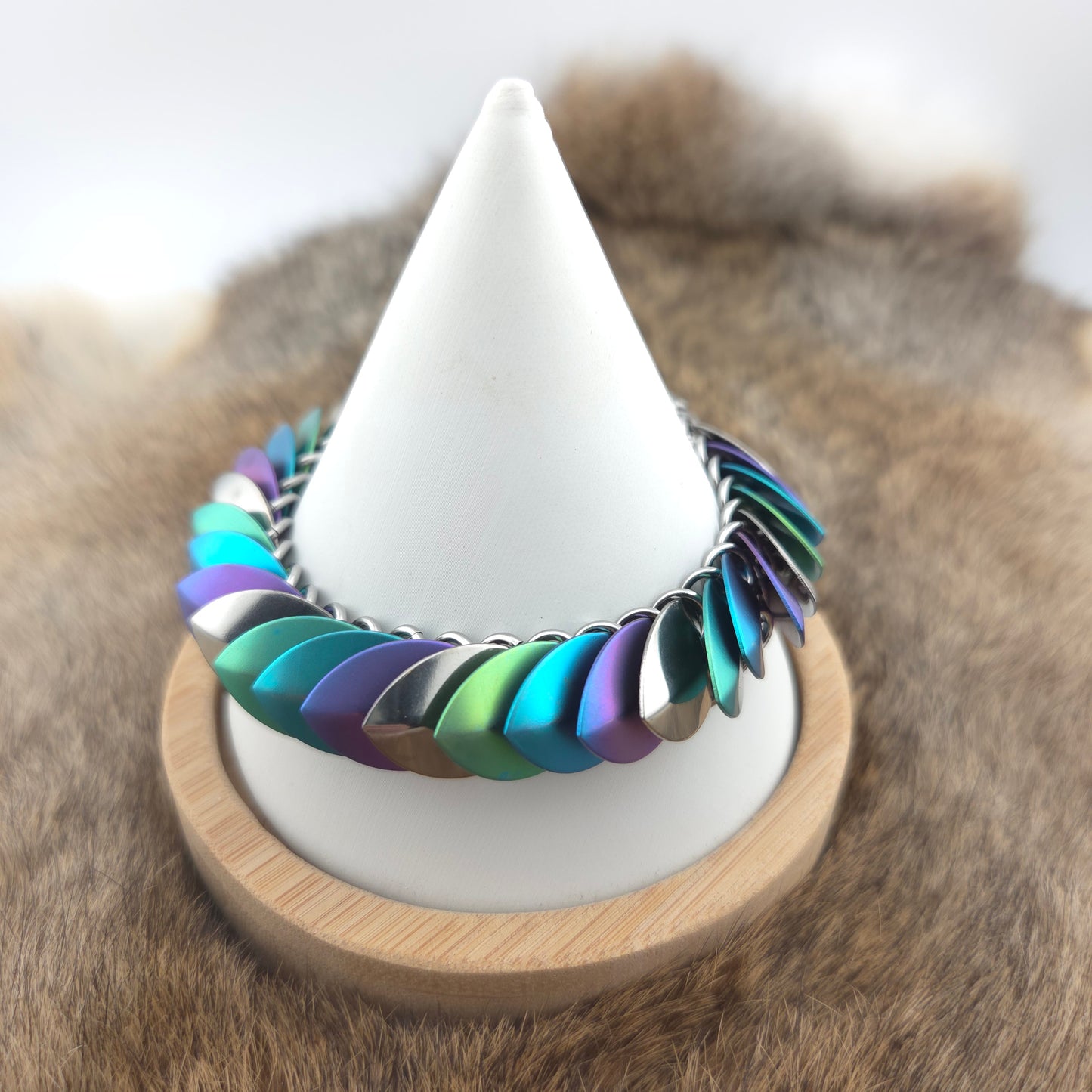 Dragon Scale Bracelet, handwoven with a stainless steel spine, silver, purple, teal, and green scales.