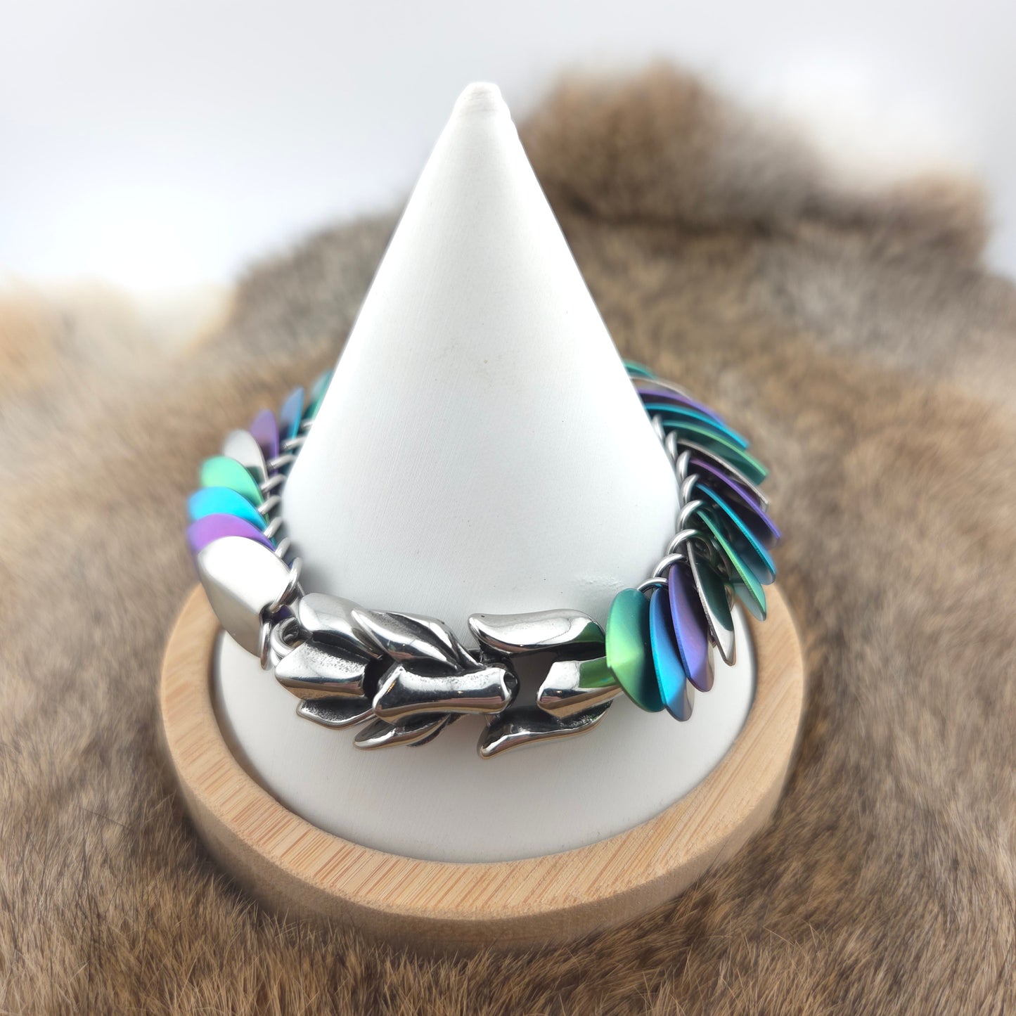 Dragon Scale Bracelet, handwoven with a stainless steel spine, silver, purple, teal, and green scales.