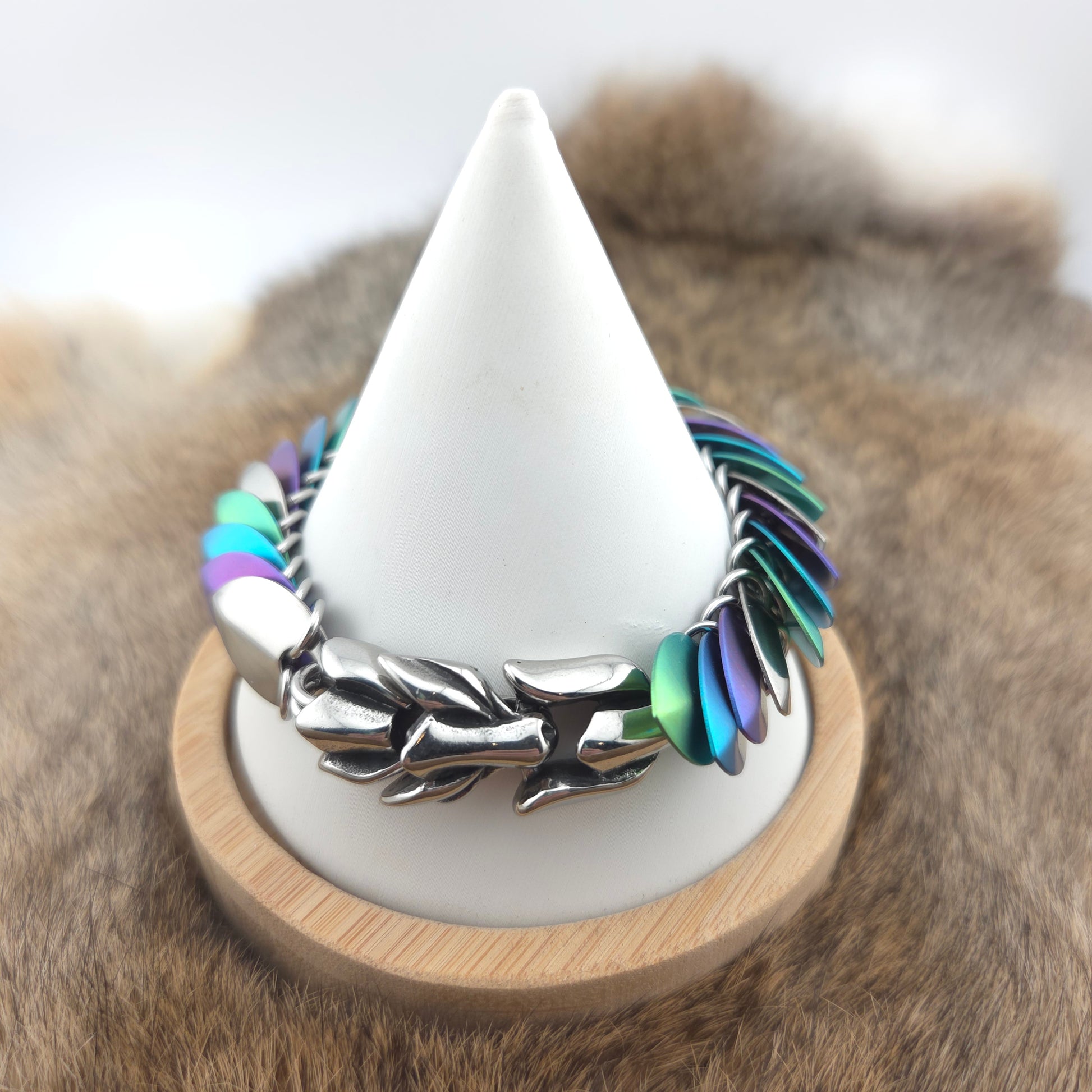 Dragon Scale Bracelet, handwoven with a stainless steel spine, silver, purple, teal, and green scales.
