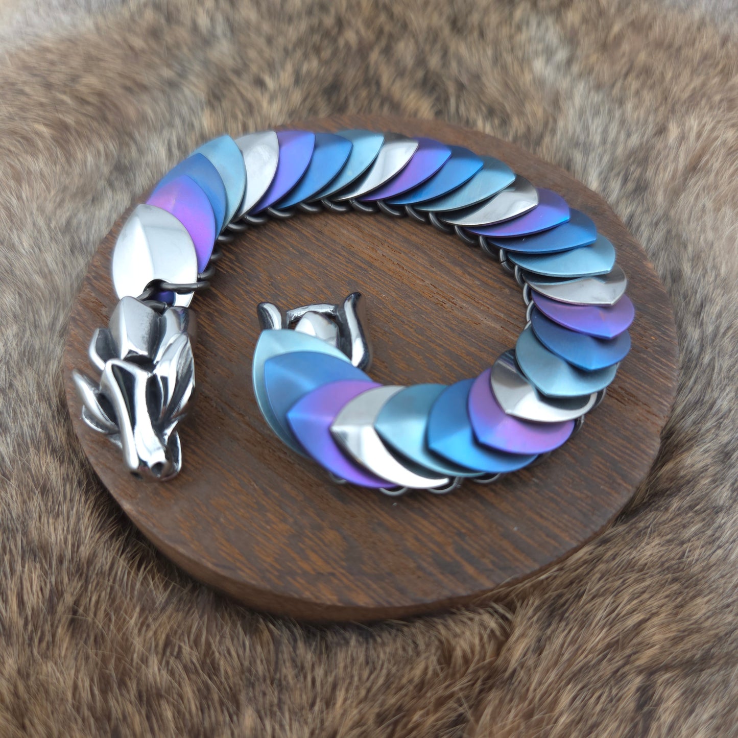 Dragon Scale Bracelet, with a stainless steel spine, stainless steel and anodized titanium  scales, and a solid stainless steel spring clasp shaped as a Dragon head.