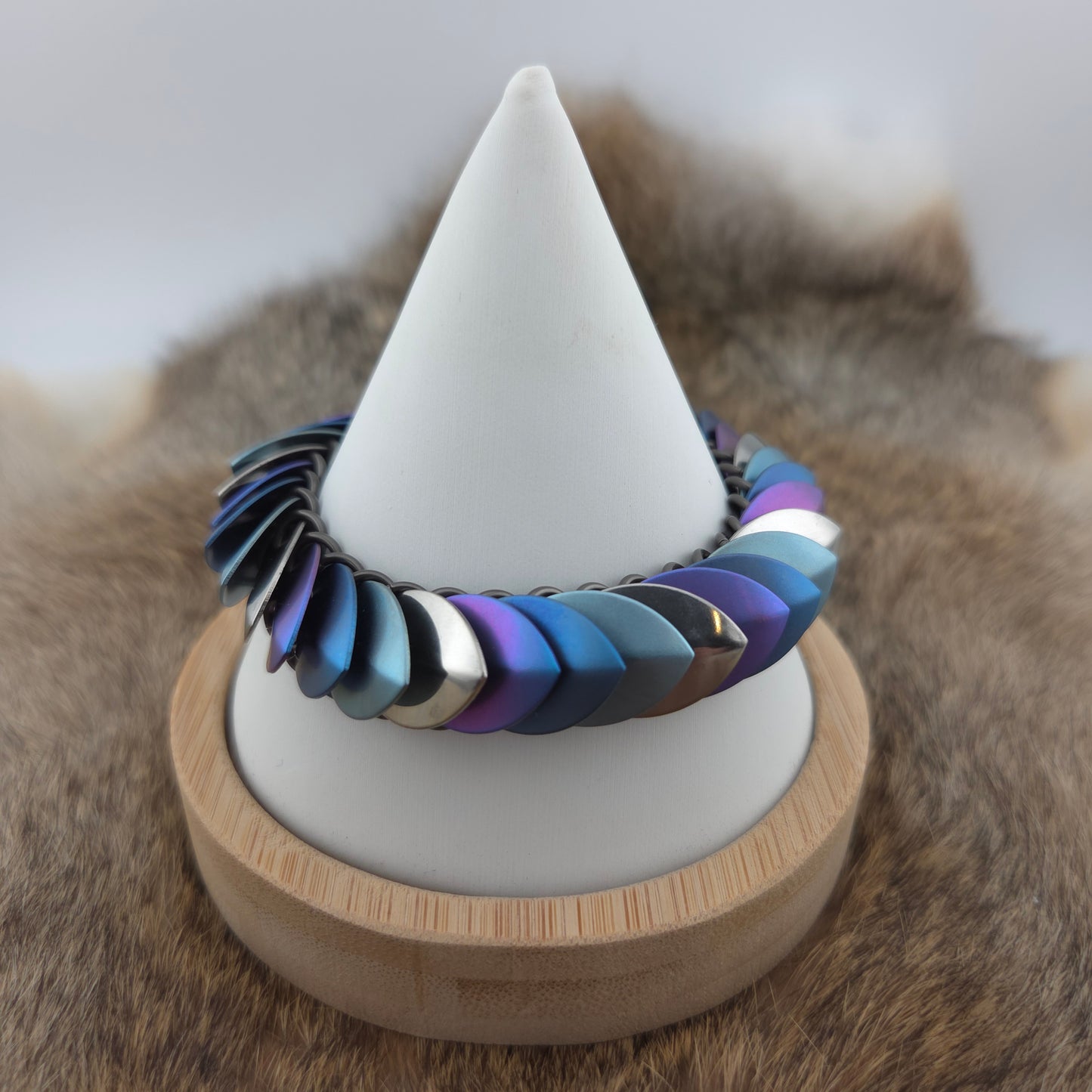 Dragon Scale Bracelet, with a stainless steel spine, stainless steel and anodized titanium  scales, and a solid stainless steel spring clasp shaped as a Dragon head.