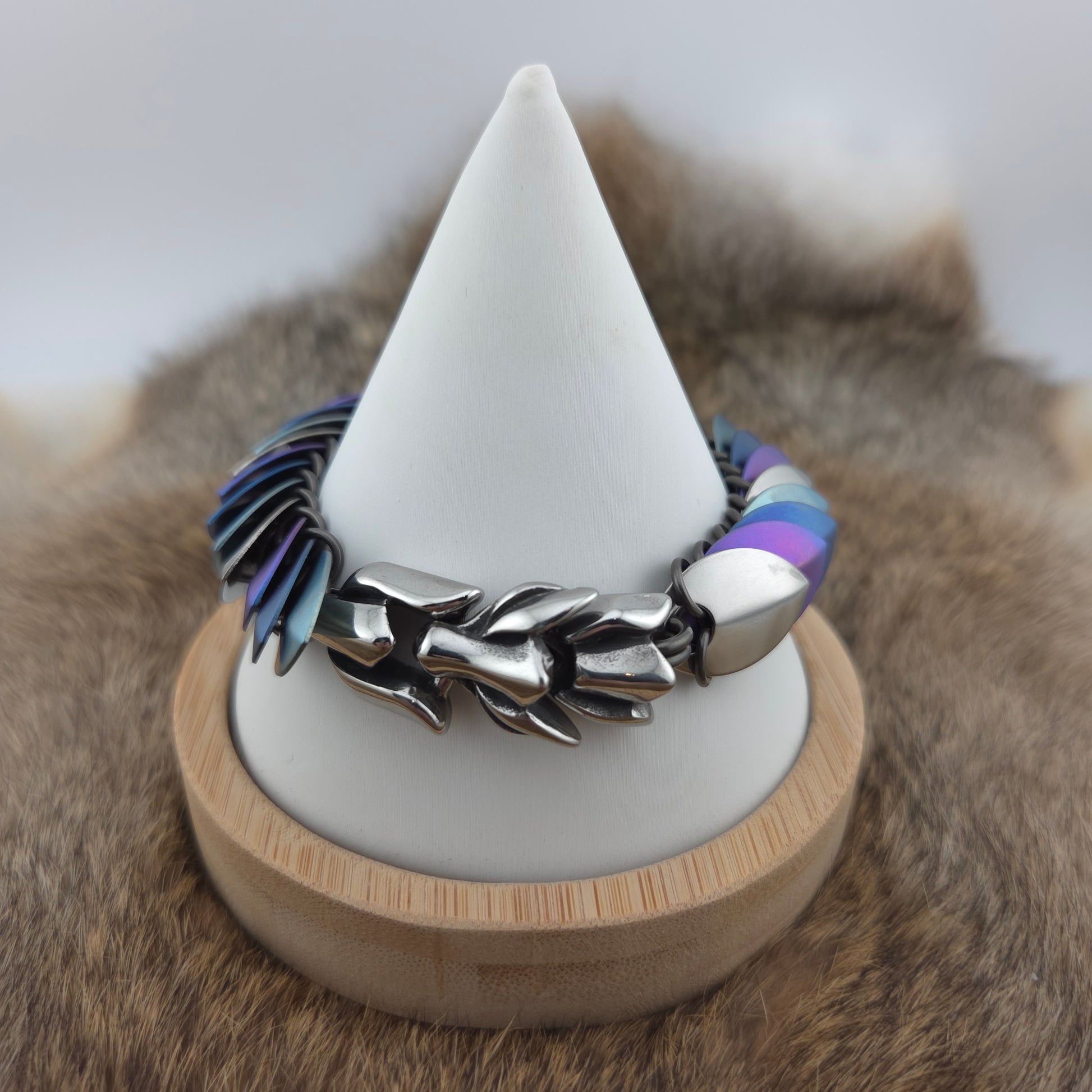 Dragon Scale Bracelet, with a stainless steel spine, stainless steel and anodized titanium  scales, and a solid stainless steel spring clasp shaped as a Dragon head.