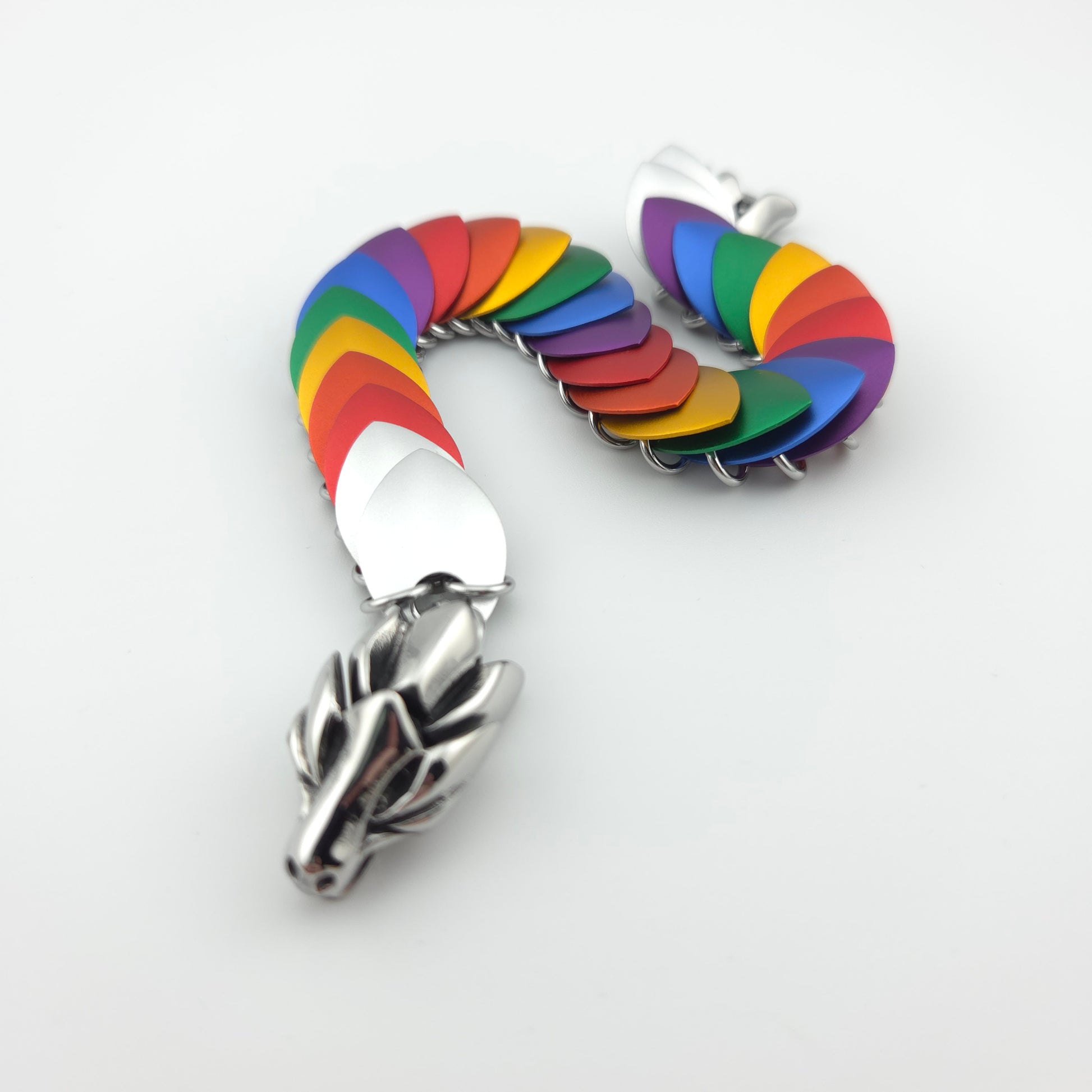 Rainbow Pride Dragon Scale Bracelet, with a stainless steel spine, premium anodized aluminum scales, and a solid stainless steel spring clasp shaped as a Dragon head.