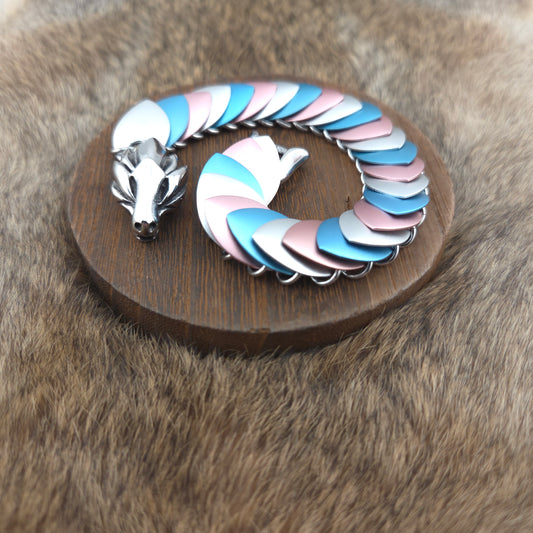 Transgender Pride Dragon Scale Bracelet, with a stainless steel spine, premium anodized aluminum scales, and a solid stainless steel spring clasp shaped as a Dragon head.